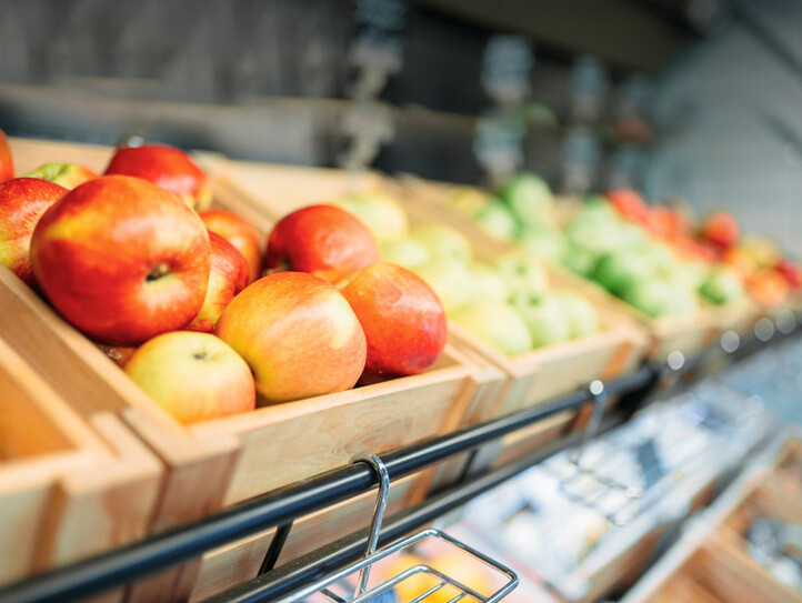 Box with fruits on stand in food store, nobody